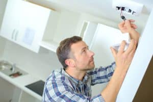 Man installing a smoke detector