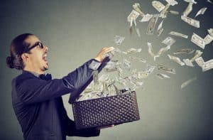 Man holding a box full of money flying around