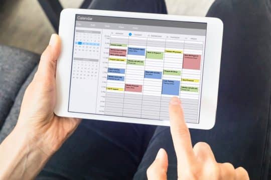 Somone looking at their calendar on their tablet