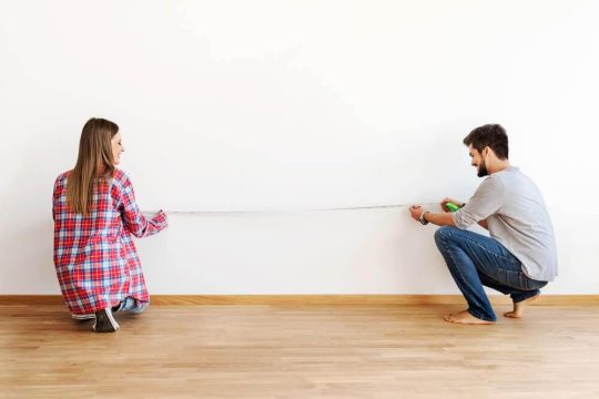 Man and woman measuring out their space