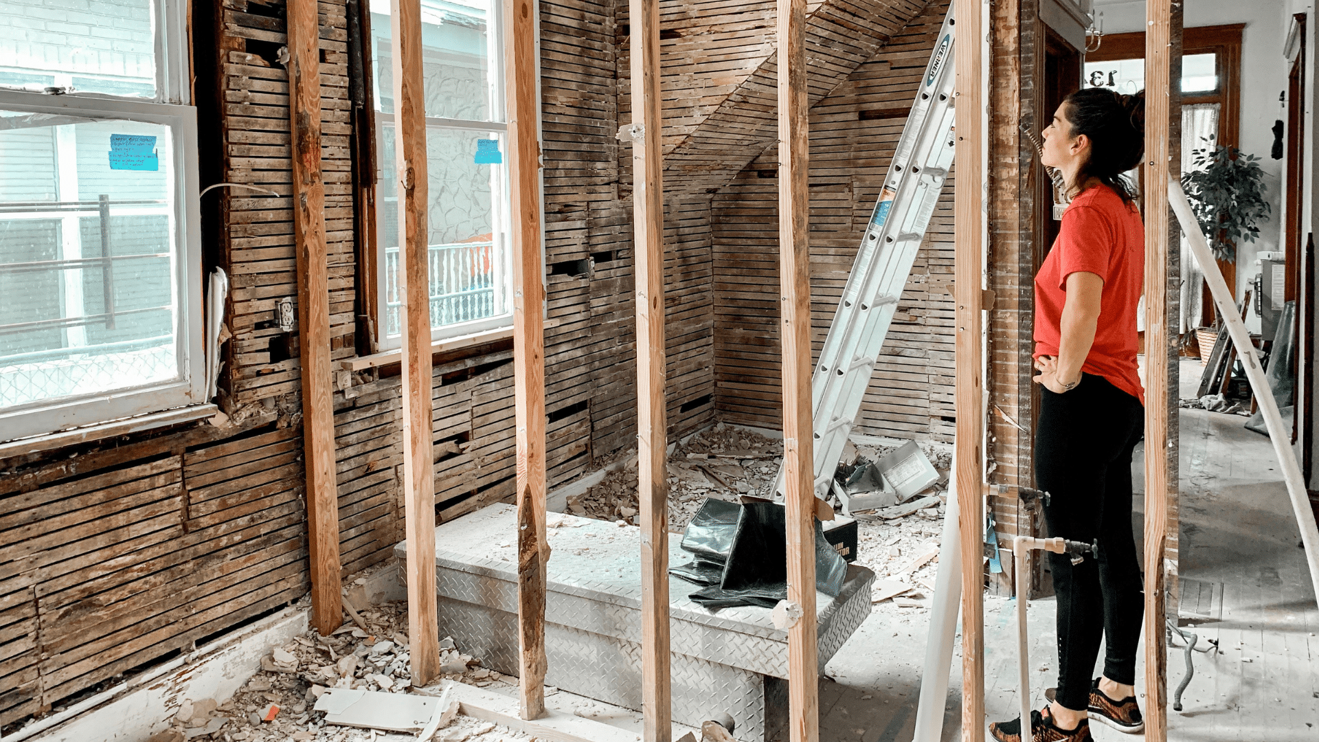 Woman looking at her house that is going through a renovation