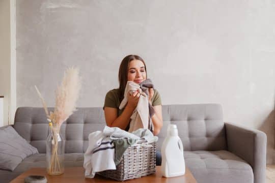 Woman smelling her laundry after using scent beads
