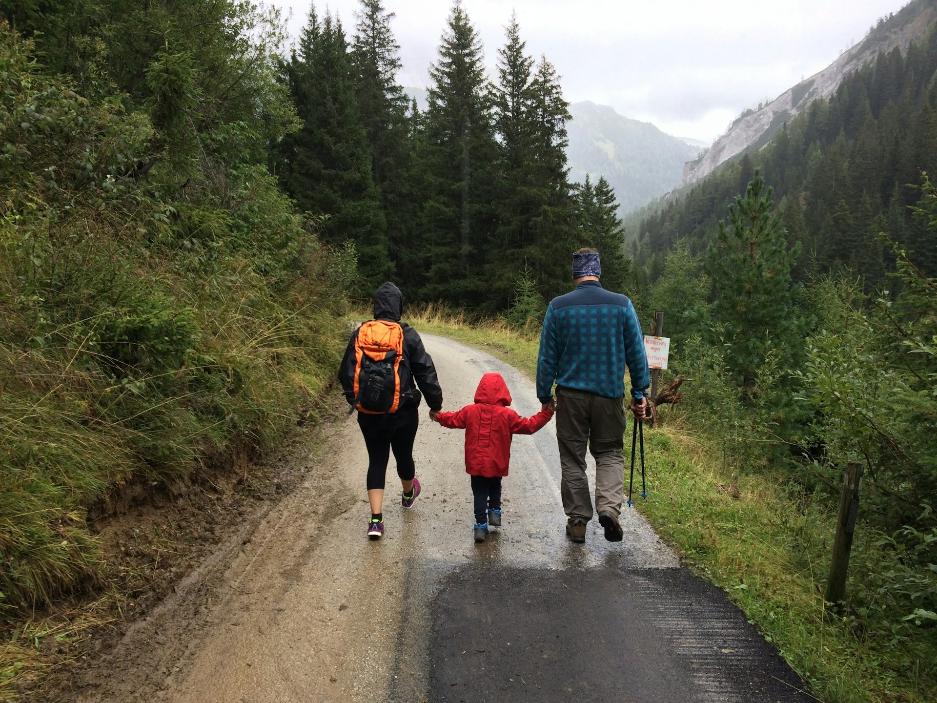 Family on a hike walking down the road