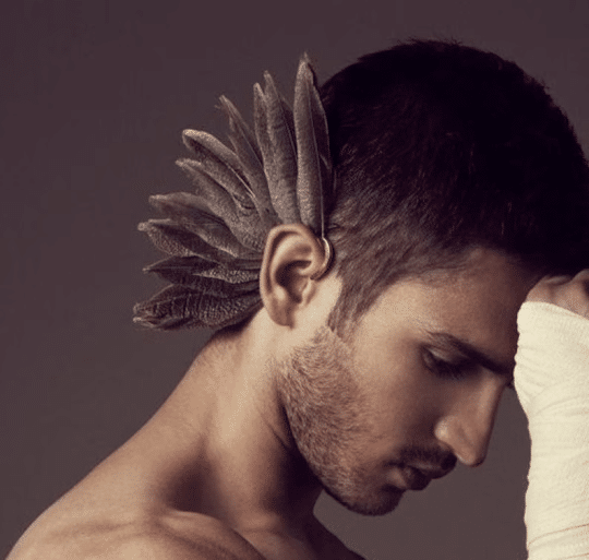 man with feather ear cuff