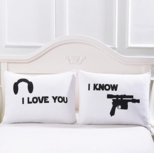 Star Wars gifts for the couple: two pillow cases. One has Prince Leia's hairline and says "I Love You." The other has a picture of Han Solo's gun and says "I Know." 