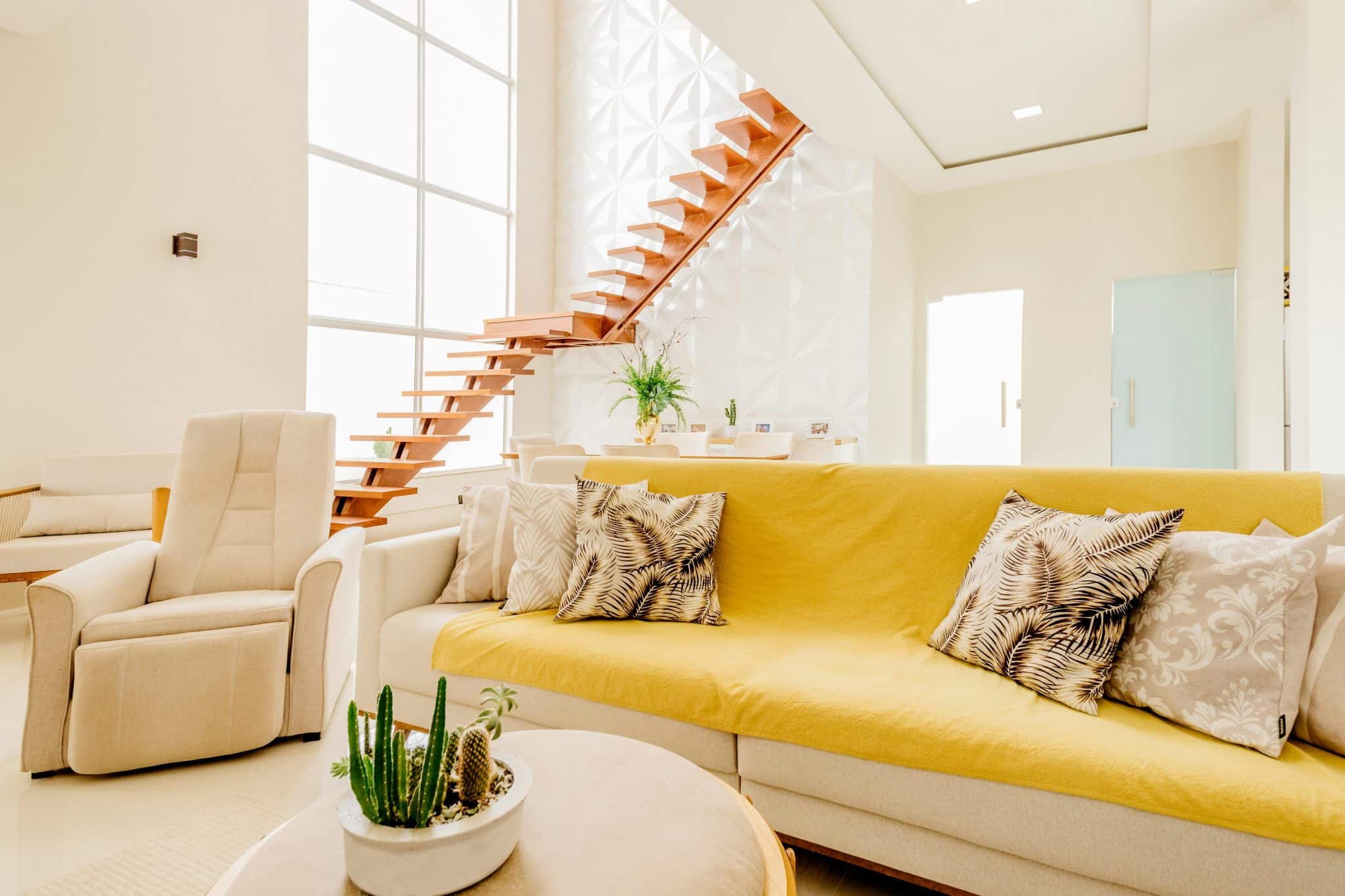 Bright modern home with white couch and lots of natural light